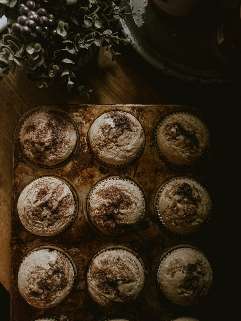 Baked muffins on a cooling rack: Freshly baked cinnamon swirl muffins cooling on a rack.