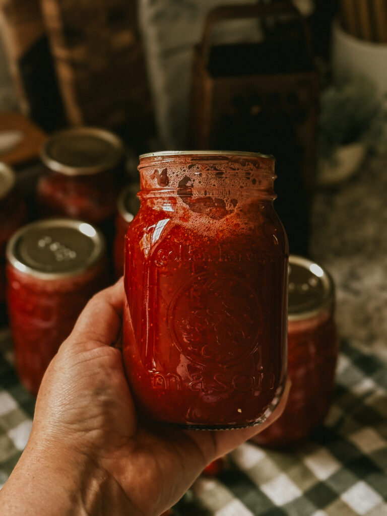Canning whole strawberries in farmhouse kitchen